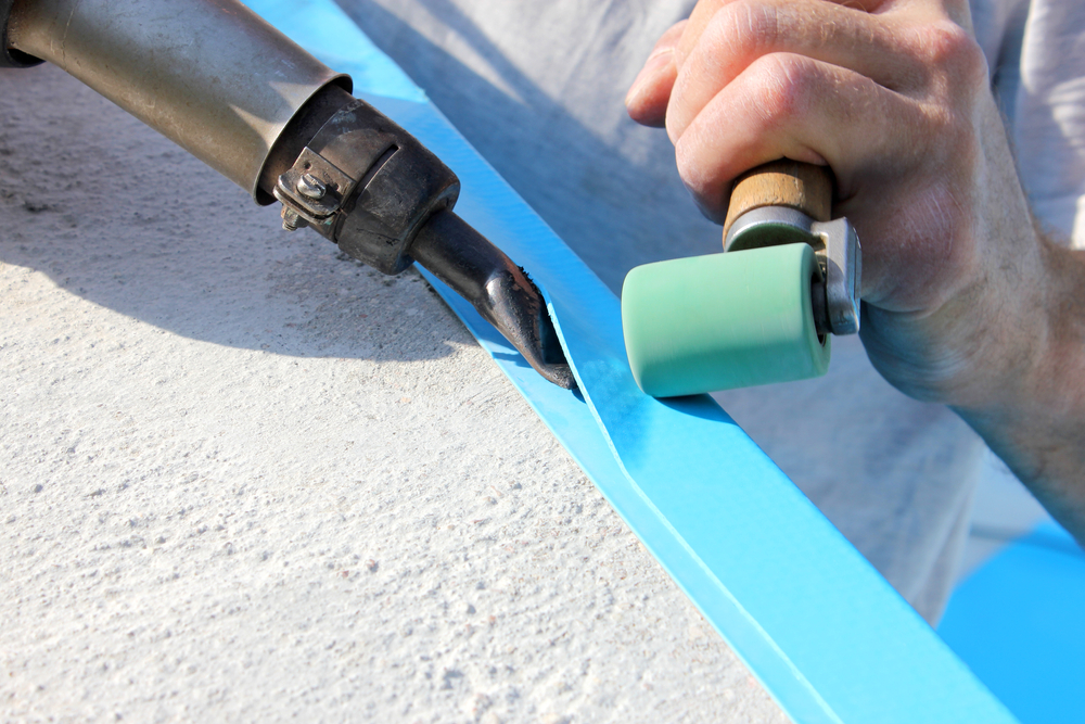 A,worker,welds,plastic,cover,for,water,pool.,water,pool